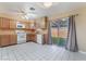Functional kitchen with white appliances and sliding glass doors to the backyard at 411 Monmouth Ct, Henderson, NV 89015