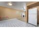 Kitchen open to living room with fireplace, white refrigerator, and tile flooring at 411 Monmouth Ct, Henderson, NV 89015
