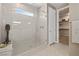 Bathroom with a glass-enclosed shower featuring tiled walls, a built-in bench, and a storage room at 4360 E Brusca Way, Pahrump, NV 89061