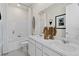 Elegant bathroom featuring double sinks, framed mirror, and tiled shower-tub at 4360 E Brusca Way, Pahrump, NV 89061