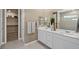 Bathroom featuring double sinks, a large mirror, and a shower; the space leads to a walk-in closet at 4360 E Brusca Way, Pahrump, NV 89061