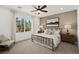 Comfortable bedroom featuring a decorative ceiling fan, neutral color palette, and large window for natural light at 4360 E Brusca Way, Pahrump, NV 89061