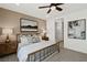 A spacious bedroom has a decorative ceiling fan, a neutral color scheme, and artwork at 4360 E Brusca Way, Pahrump, NV 89061