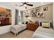 Bright bedroom features two beds, a ceiling fan, and fun art at 4360 E Brusca Way, Pahrump, NV 89061