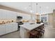 Bright kitchen featuring white cabinets, a spacious island with seating, and modern lighting at 4360 E Brusca Way, Pahrump, NV 89061