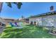 Grassy backyard with mature tree, outdoor furniture for relaxing and entertaining at 4445 Peterson Dr, Las Vegas, NV 89103