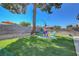A backyard is set up with comfortable Adirondack chairs on a grassy area at 4445 Peterson Dr, Las Vegas, NV 89103