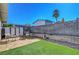 Backyard area with seating, grassy section, and a shed for storage at 4445 Peterson Dr, Las Vegas, NV 89103