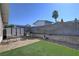 Backyard with artificial turf, stone accents, and a storage shed at 4445 Peterson Dr, Las Vegas, NV 89103