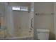Bathroom with shower-tub combination featuring storage shelves and grab bar at 4445 Peterson Dr, Las Vegas, NV 89103