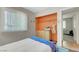 Well-lit bedroom with a built-in closet, neutral walls, and minimalist decor at 4445 Peterson Dr, Las Vegas, NV 89103