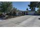 Single-story home with an attached two-car garage and an ample concrete driveway at 4445 Peterson Dr, Las Vegas, NV 89103