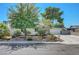 Charming single-story home with mature trees, a well-maintained lawn and a two car garage at 4445 Peterson Dr, Las Vegas, NV 89103