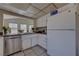 Functional kitchen featuring white cabinets, stainless steel appliances, with a view of the office at 4445 Peterson Dr, Las Vegas, NV 89103
