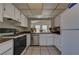 Functional kitchen featuring white cabinets, stainless steel appliances, and a pass-through to the adjacent room at 4445 Peterson Dr, Las Vegas, NV 89103