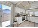Cozy kitchen featuring white cabinets, stainless steel appliances and a sliding glass door to the patio at 4445 Peterson Dr, Las Vegas, NV 89103