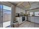 Functional kitchen featuring white cabinets, stainless steel appliances, and easy access to the outdoor patio at 4445 Peterson Dr, Las Vegas, NV 89103