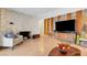 Living room featuring a stone fireplace, wood panel accents and ample seating at 4445 Peterson Dr, Las Vegas, NV 89103