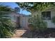 A private side yard enclosed by a secure gate and surrounded by mature landscaping at 4445 Peterson Dr, Las Vegas, NV 89103