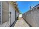 Cemented side yard features a block wall and access to the backyard at 4445 Peterson Dr, Las Vegas, NV 89103