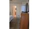 Bedroom with carpeted floor, and dresser with open bathroom view at 4555 Sahara Ave # 252, Las Vegas, NV 89104