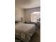 Bedroom with carpeted floor, bed, table, a window with blinds, and a desk at 4555 Sahara Ave # 252, Las Vegas, NV 89104
