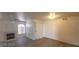 Living room with a fireplace, ceiling fan, wood-look flooring, and an adjacent room at 4555 Sahara Ave # 252, Las Vegas, NV 89104