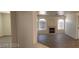 Bright living room with fireplace, ceiling fan, and modern vinyl flooring at 4555 Sahara Ave # 252, Las Vegas, NV 89104
