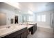 Bright bathroom with a separate shower and tub, double sinks, and large mirror with vanity lighting at 4652 Wyncrest Ave, Las Vegas, NV 89115