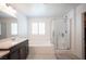 Well-lit bathroom features a luxurious tub, glass-enclosed shower, and modern vanity with dual sinks at 4652 Wyncrest Ave, Las Vegas, NV 89115