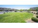 A beautiful neighborhood park with lush green grass, trees, and a playground at 4652 Wyncrest Ave, Las Vegas, NV 89115