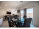 Bright dining area with glass table and sliding glass door to backyard at 4652 Wyncrest Ave, Las Vegas, NV 89115