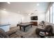 Spacious living area featuring modern furnishings, a pool table and bright windows at 4652 Wyncrest Ave, Las Vegas, NV 89115