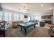 Spacious living room with plush seating, pool table, and modern entertainment center at 4652 Wyncrest Ave, Las Vegas, NV 89115