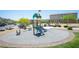 Community playground featuring a slide, seesaw, and shaded seating area at 4652 Wyncrest Ave, Las Vegas, NV 89115