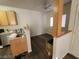 Well-lit dining area with wood-look floors, a ceiling fan, and views into the kitchen and living spaces at 4730 E Craig Rd # 1106, Las Vegas, NV 89115