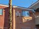 Close-up view of the exterior of a condo, showing unit numbers and exterior wall texture under a clear blue sky at 4730 E Craig Rd # 1106, Las Vegas, NV 89115