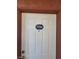 A close view of a white front door with dark brown trim and a unit number plaque at 4730 E Craig Rd # 1106, Las Vegas, NV 89115