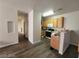 Open-concept kitchen with wood cabinets, white appliances, breakfast bar, and wood-look flooring in a well-lit space at 4730 E Craig Rd # 1106, Las Vegas, NV 89115