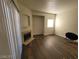 Living room featuring dark wood-look flooring, a cozy fireplace, and a bright window at 4730 E Craig Rd # 1106, Las Vegas, NV 89115