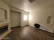 Spacious living room with dark wood-look flooring, a cozy fireplace, and a bright window at 4730 E Craig Rd # 1106, Las Vegas, NV 89115