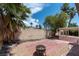 Backyard with brick patio, low-maintenance gravel, and palm trees offering an inviting outdoor space at 4904 Wiltondale Way, Las Vegas, NV 89130