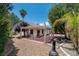 View of a backyard featuring a covered patio, desert landscaping, and ample space for outdoor relaxation and entertaining at 4904 Wiltondale Way, Las Vegas, NV 89130