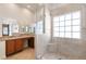 Modern bathroom featuring a glass-enclosed shower, vanity, and a large window at 4904 Wiltondale Way, Las Vegas, NV 89130