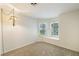 Bright bedroom featuring carpet floors, a pendant light and two large windows at 4904 Wiltondale Way, Las Vegas, NV 89130