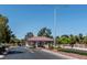 Community entry gate featuring a covered entryway and lush landscaping at 4904 Wiltondale Way, Las Vegas, NV 89130