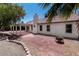 Exterior view of home with a covered patio, brick patio, desert landscape, and chimney at 4904 Wiltondale Way, Las Vegas, NV 89130