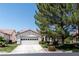 Charming single-story home featuring a two-car garage, well-manicured lawn, and mature shade tree at 4904 Wiltondale Way, Las Vegas, NV 89130