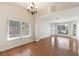 Bright living room with hardwood floors, large windows, and a stylish chandelier at 4904 Wiltondale Way, Las Vegas, NV 89130