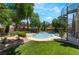 A spacious backyard features a sparkling pool, spa, and lush greenery, creating a tranquil retreat at 5186 San Milano Ave, Las Vegas, NV 89141